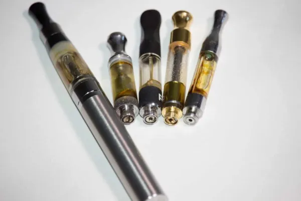 Close-up image of a sleek DMT vape pen with glowing vapor
