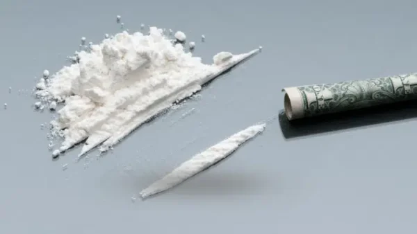 High-purity powder cocaine in a sealed clear bag on a black background